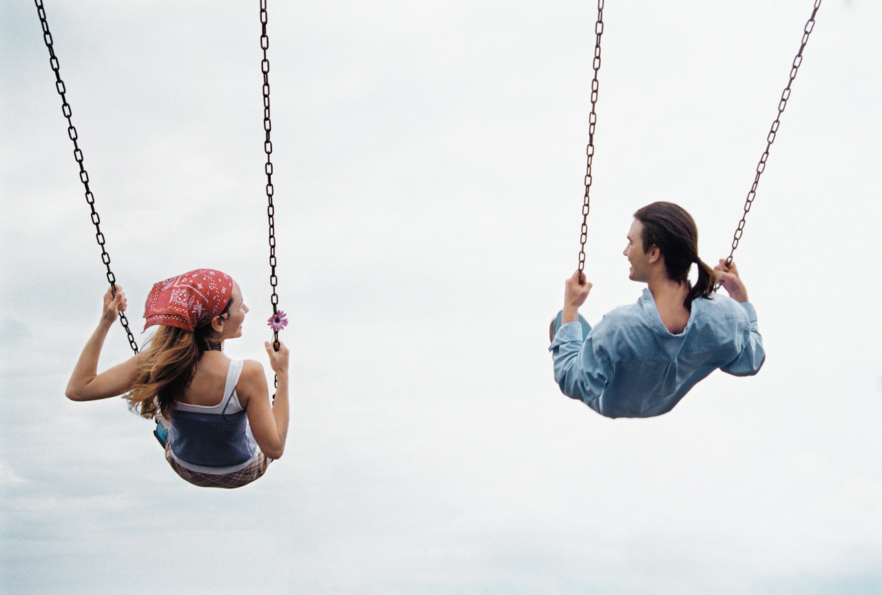 Couple Playing on a Swing